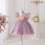 Children's dress with star pattern on a mannequin against a white wall.