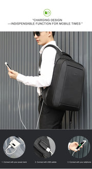 Person wearing a black backpack with charging design features, holding a phone and power bank.