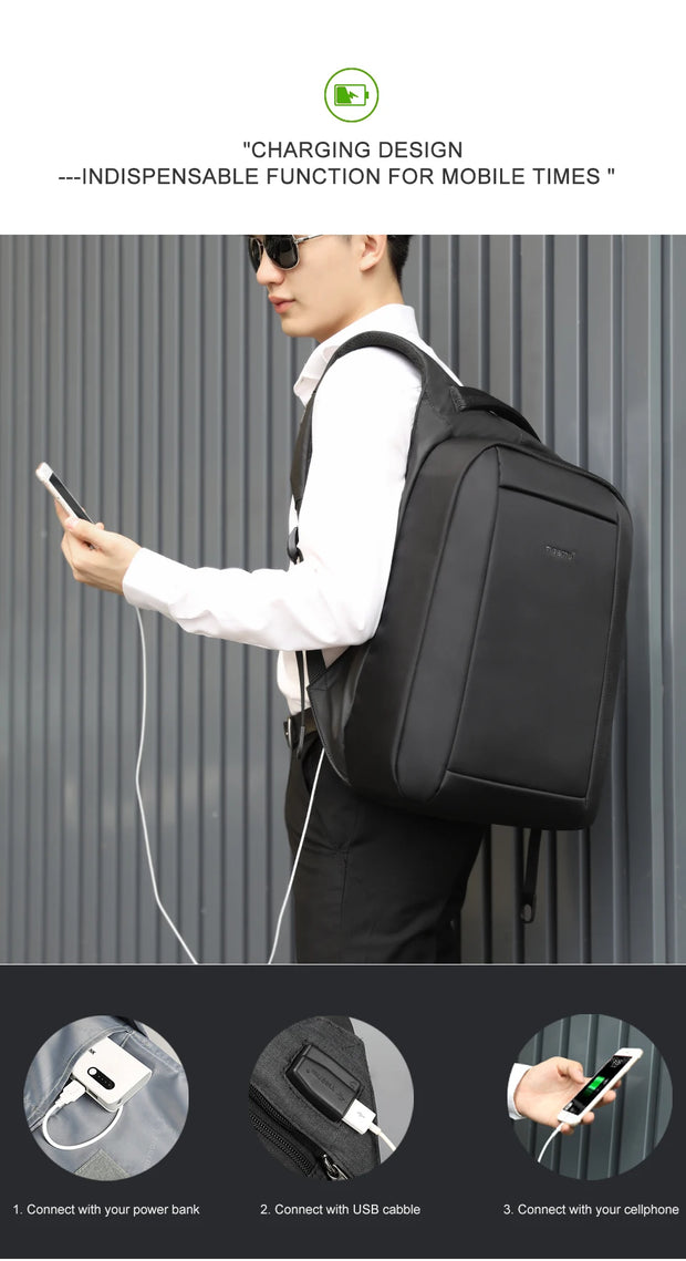 Person wearing a black backpack with charging design features, holding a phone and power bank.