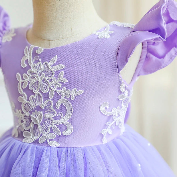 Purple dress with white floral lace on a mannequin against a neutral background