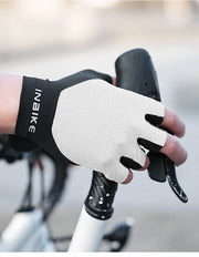 Person wearing a black and white holding bicycle handlebars.