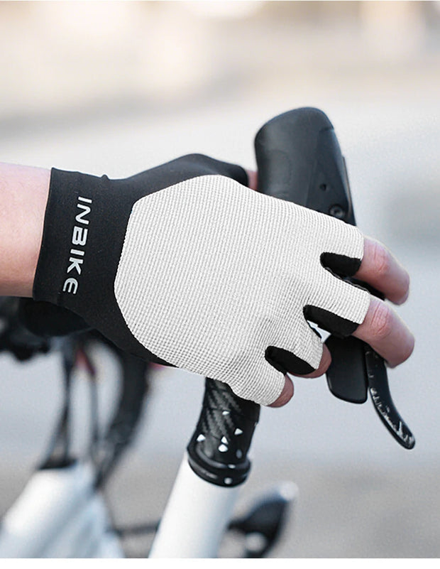 Person wearing a black and white holding bicycle handlebars.