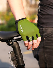 Green cycling glove on a person's hand with a blurred background