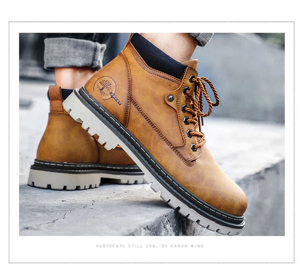 Brown leather boots with white soles on a stone surface