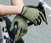 Green gloves with black accents held by a person on a bicycle