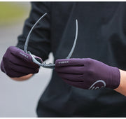Person wearing purple gloves holding sunglasses 