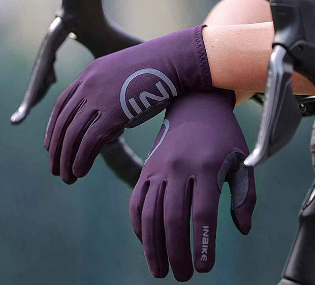 Purple gloves on a blurred background of bicycle handlebars