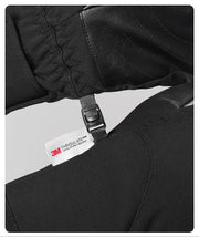 Close-up of a black jacket with a Thinsulate label on a white background