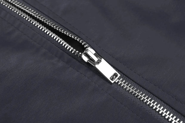 Close-up of a silver zipper on a dark fabric background