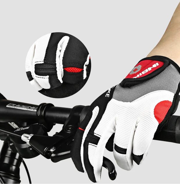 Close-up of a black and white glove with red accents on a bike handlebar, with a detailed view of the glove's texture.