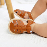 Brown woven sandals on a light background
