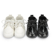 Pair of white and black shoes on a white background