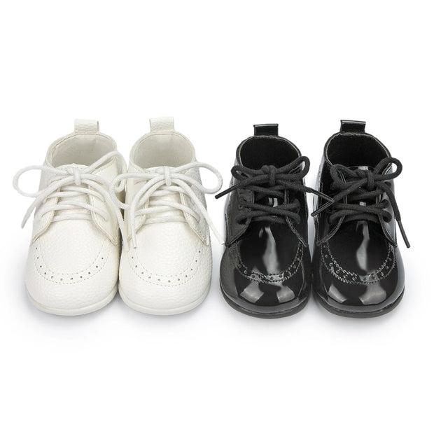Pair of white and black shoes on a white background