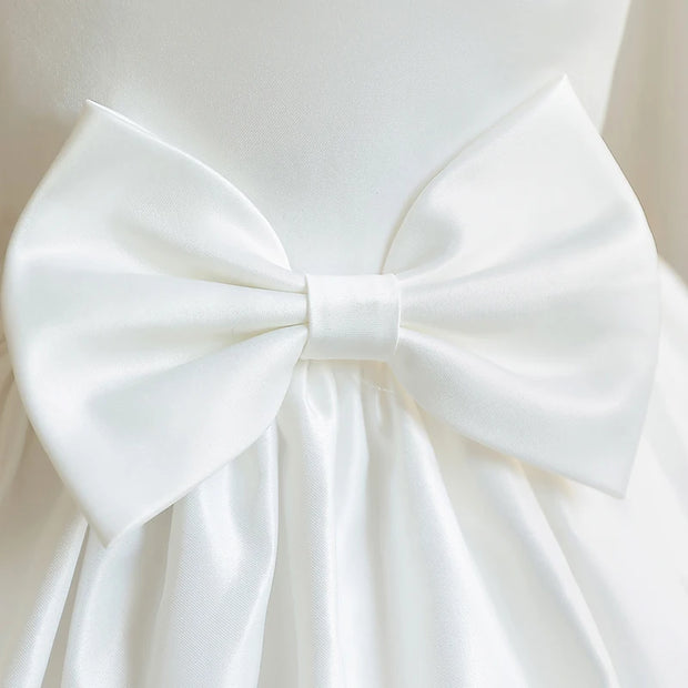 Close-up of a large white bow on a plain background