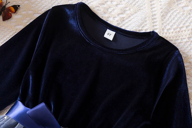Navy blue long-sleeve shirt on a textured surface with a butterfly.