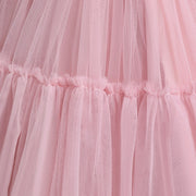 Close-up of a pink tulle skirt with ruffled layers.