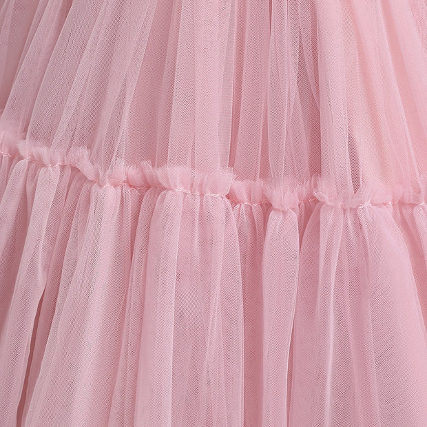 Close-up of a pink tulle skirt with ruffled layers.