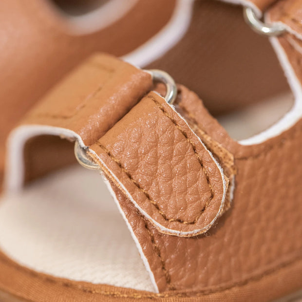 Close-up of a brown leather shoe with a buckle