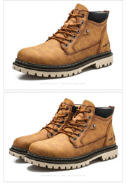 Pair of brown work boots with white soles on a white background