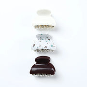 Set of three hair clips with different designs on a white background
