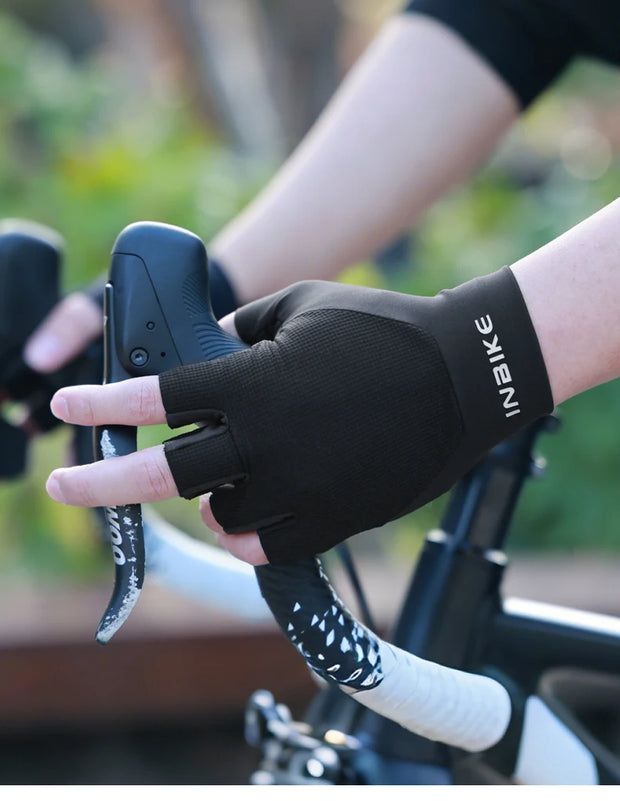 Person wearing a black bike glove on a bicycle with blurred background