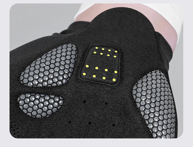 Close-up of a black shoe with textured sole and yellow accents on a gray background