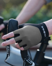 Person wearing a cycling glove holding a phone with a blurred background