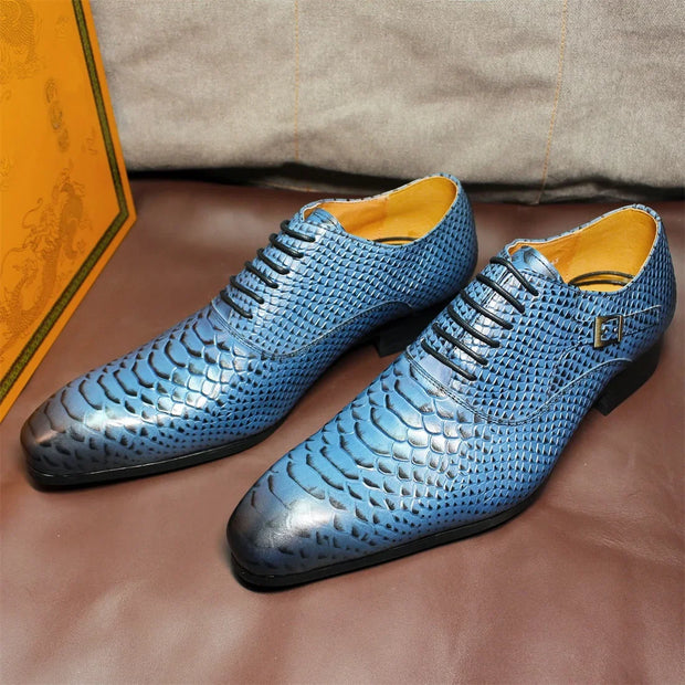 Blue patterned shoes on a brown surface with a box in the background