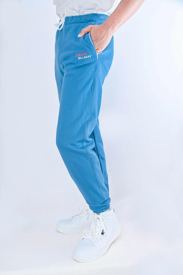 Person wearing blue pants with text on a white background