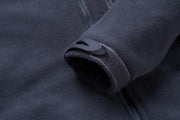 Close-up of a dark gray fleece jacket with a zipper