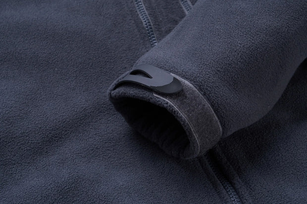 Close-up of a dark gray fleece jacket with a zipper