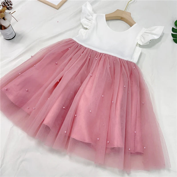 Pink and white dress with a tutu skirt on a white background