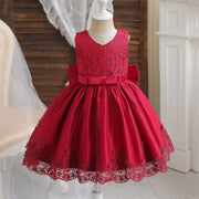 Red lace dress on a mannequin against a neutral background