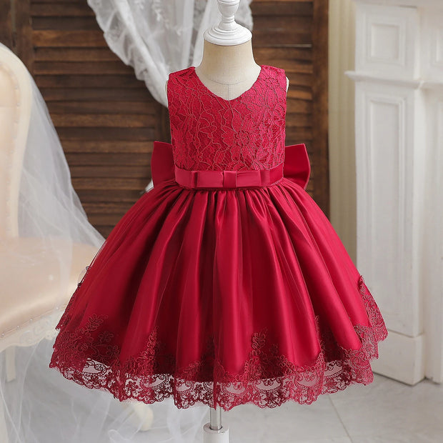 Red lace dress on a mannequin against a neutral background