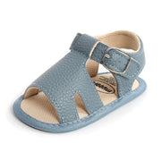 Blue baby sandal with a buckle on a white background