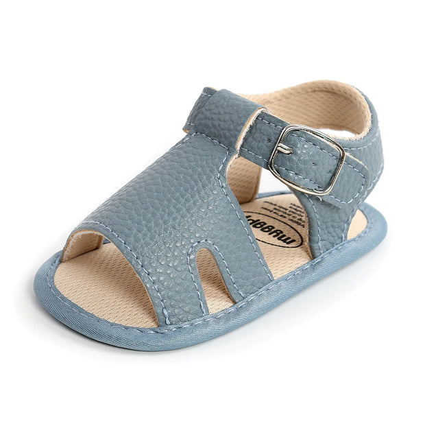 Blue baby sandal with a buckle on a white background