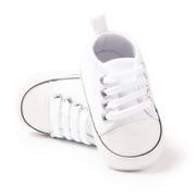 White high-top sneakers on a white background