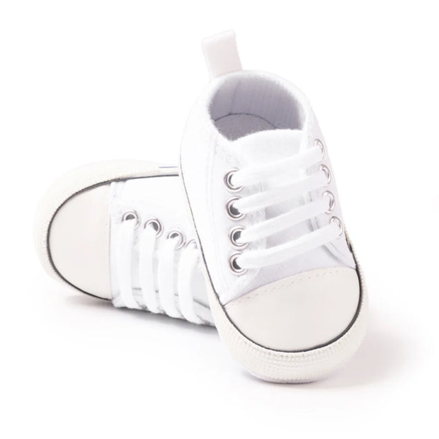 White high-top sneakers on a white background