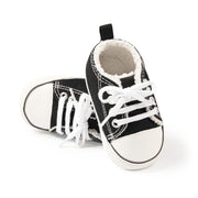 Black and white baby sneakers on a white background