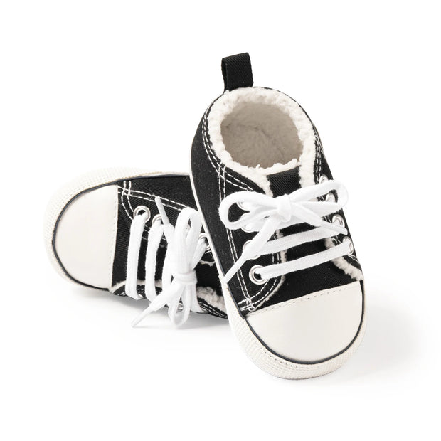 Black and white baby sneakers on a white background