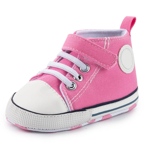 Pink high-top sneaker with white laces on a white background