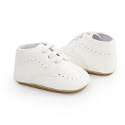 White baby shoes on a white background