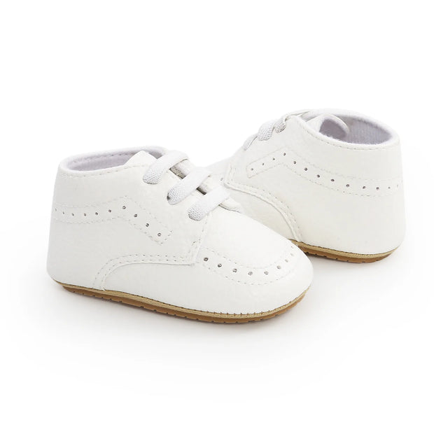 White baby shoes on a white background