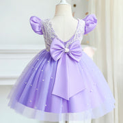 Lavender dress with a large bow on a mannequin against a white background