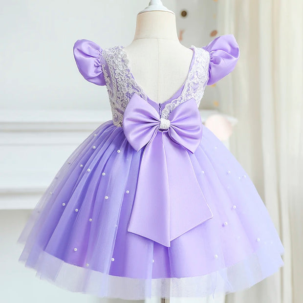 Lavender dress with a large bow on a mannequin against a white background