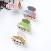 Three colorful hair clips on a white background