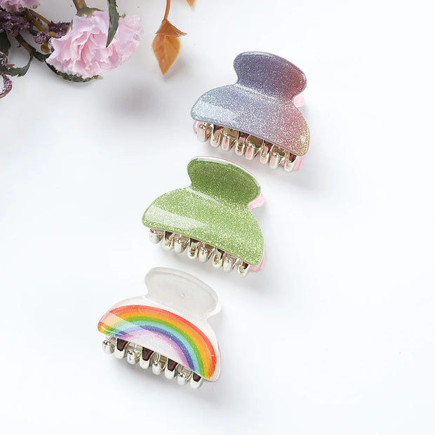 Three colorful hair clips on a white background