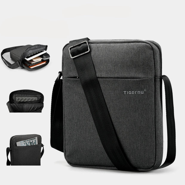 Gray shoulder bag with a black strap, on a white background.