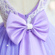Close-up of a lavender dress with a large bow and lace details on a mannequin.