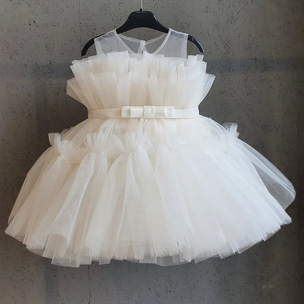 White tulle dress on a hanger against a gray background